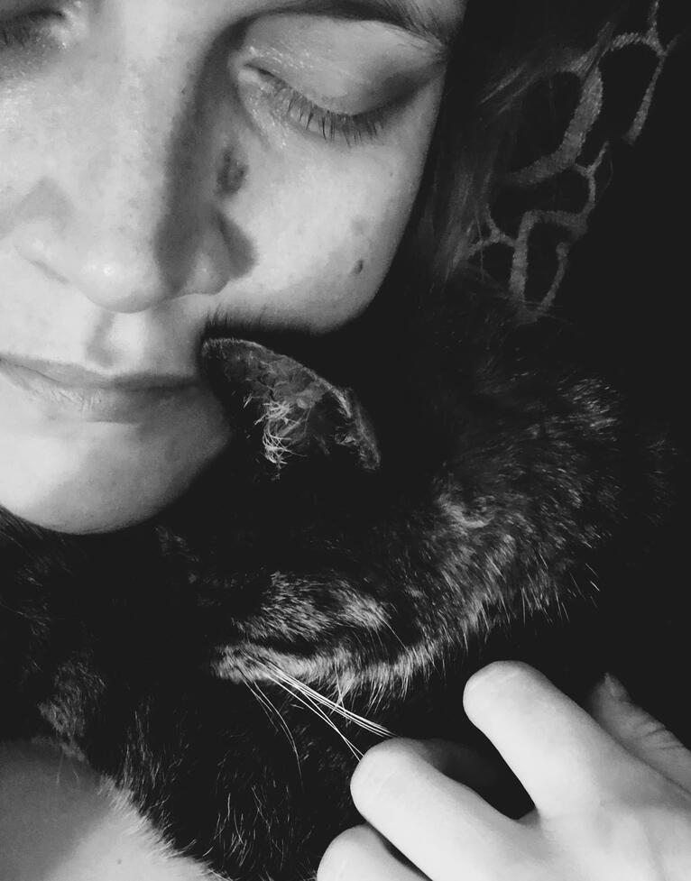 Photo of Jennika and her cat Luna in black and white.